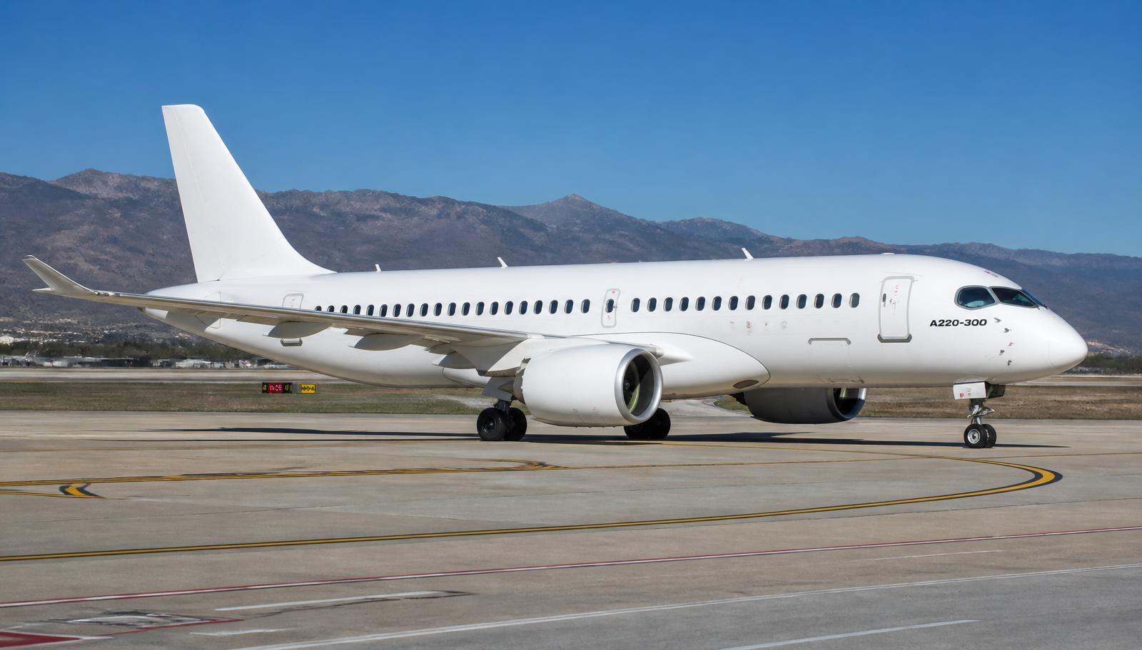 Airbus A220 taxiing on an airport taxiway in daylight