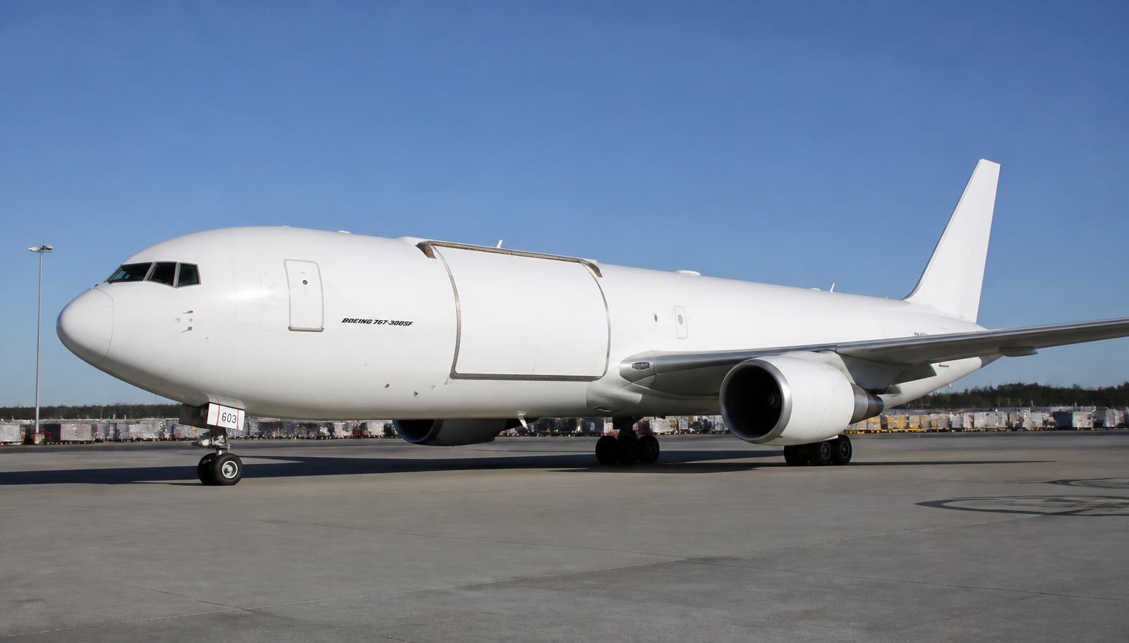 Boeing 767 freighter taxiing on an airport taxiway in daylight