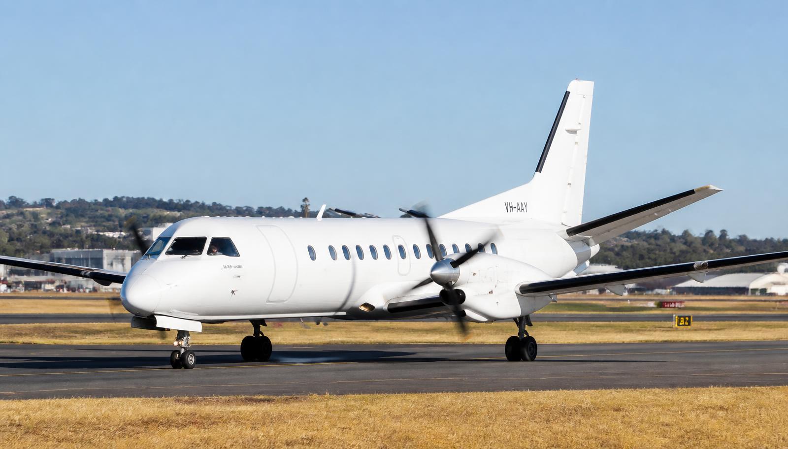 Saab 340 taxiing on an airport taxiway in daylight